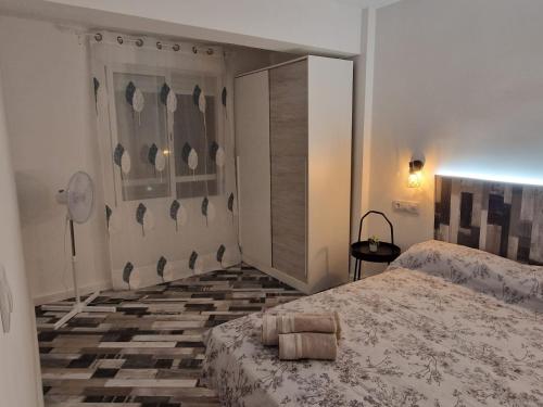 a bedroom with two beds and a tiled floor at Selena Beach in Cullera