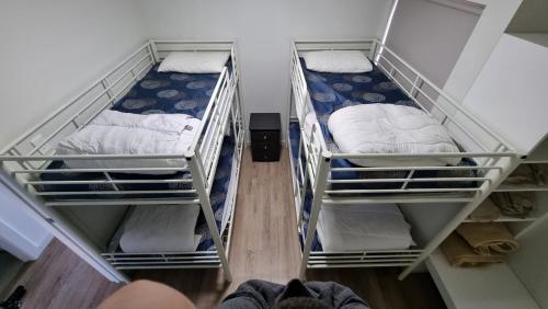 a room with two bunk beds and a person standing in a room at Wallaroo Holiday Park in Wallaroo