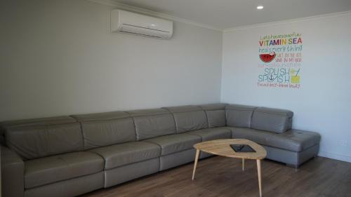 a living room with a couch and a table at Wallaroo Holiday Park in Wallaroo