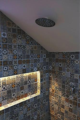 a bathroom with a tiled wall and a ceiling at Casa Crónica in Oaxaca City