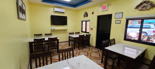 a dining room with tables and chairs in a restaurant at Saipan Beach Hotel in Saipan