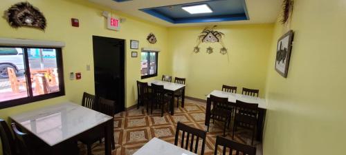 a dining room with tables and chairs in a restaurant at Saipan Beach Hotel in Saipan