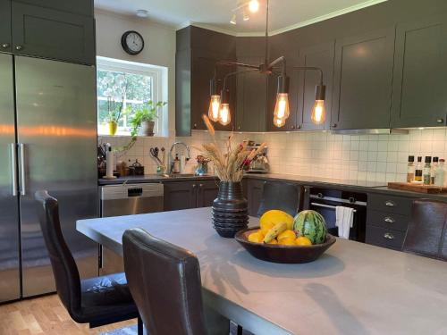 a kitchen with a table with a bowl of fruit on it at 5 person holiday home in KLÖVEDAL-By Traum in Klövedal