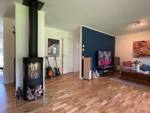 a living room with a fireplace in the middle at 5 person holiday home in KLÖVEDAL-By Traum in Klövedal