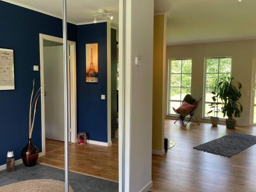 a living room with blue walls and wooden floors at 5 person holiday home in KLÖVEDAL-By Traum in Klövedal