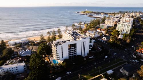 an aerial view of a city and the ocean at Novotel Wollongong Northbeach in Wollongong