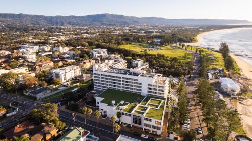 an aerial view of a city and the beach at Novotel Wollongong Northbeach in Wollongong