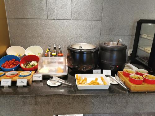 a kitchen counter with some food and pots and pans at Sincere Residence Changfeng - Changfeng Ecological Business District - Near Exit 3 of Changfeng Park Station on Subway Line 15 in Shanghai