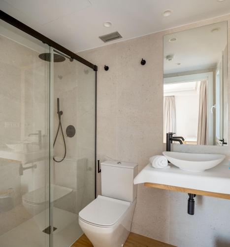 a bathroom with a toilet and a sink and a shower at Hotel Boutique Berazadi Berri in Zarautz