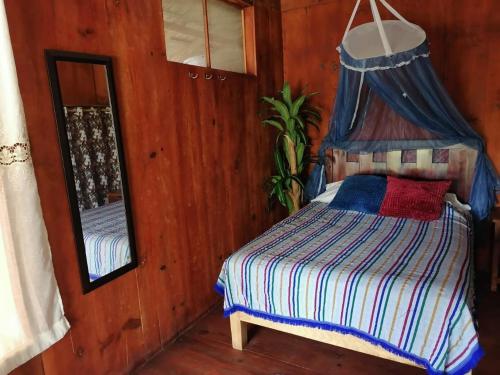 una camera con letto a baldacchino e specchio di Villas La Bella Margarita a Brisas de Zicatela