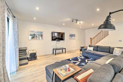 a living room with a couch and a tv at 1 Mi to Tunnel Park Holland Home with Fire Pit in Holland