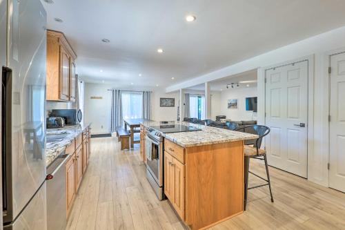 a kitchen with wooden cabinets and a counter top at 1 Mi to Tunnel Park Holland Home with Fire Pit in Holland