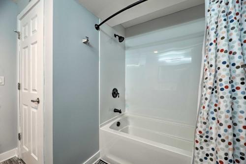 a white bathroom with a shower and a tub at 1 Mi to Tunnel Park Holland Home with Fire Pit in Holland