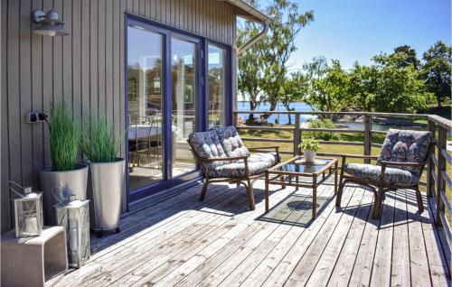 a deck with two chairs and a coffee table at 2 Bedroom Stunning Home In Oskarshamn in Oskarshamn