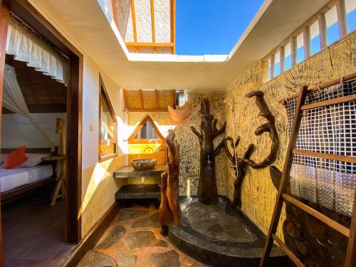 a room with a bed and a room with a window at Sayang Mama Inn in Gili Air