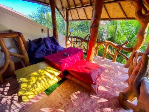 a room with two pillows sitting on a porch at Sayang Mama Inn in Gili Air