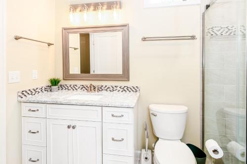 a white bathroom with a sink and a shower at Blue House on Blythe in Hendersonville