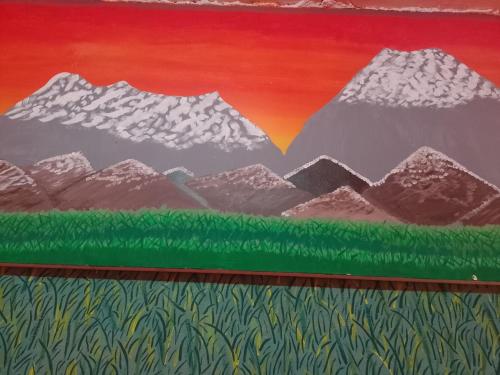 a painting of a mountain range with green grass at Alo México in Mexico City
