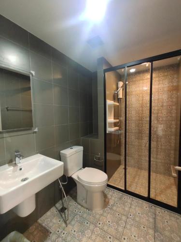 a bathroom with a toilet and a sink and a shower at Rose 'Lacasita Huahin in Hua Hin