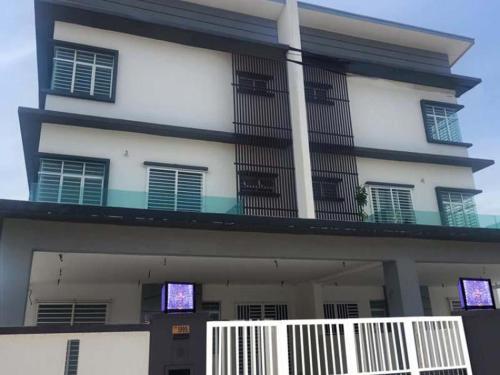 a large white building with a balcony on it at Villa Chee in Sekincan