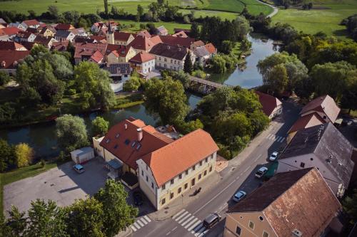 an aerial view of a town next to a river at Ob Krki Apartments in Kostanjevica na Krki
