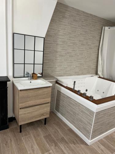 a large bathroom with a tub and a sink at Loft ravissant 45m2 Jacuzzi RVB NIGHT 2 in Amiens