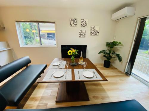 a living room with a table and a couch at Compass Duo in Karuizawa