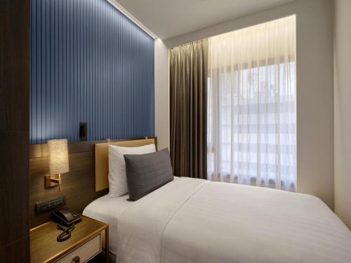 Katil atau katil-katil dalam bilik di Sindhorn Midtown Hotel Bangkok, Vignette Collection by IHG