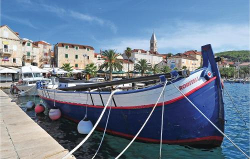 a boat is docked at a dock in the water at 2 Bedroom Stunning Apartment In Supetar in Supetar