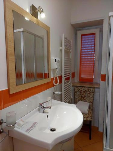 a bathroom with a white sink and a mirror at Villa Margot in Agropoli
