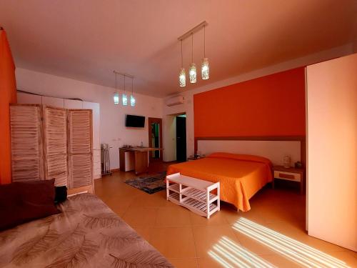 a bedroom with an orange bed in a room at Villa Margot in Agropoli