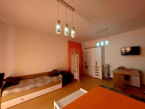 a room with a bed and a desk in it at Villa Margot in Agropoli