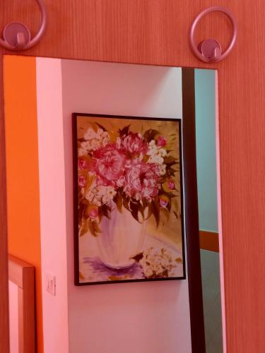 a painting of a vase of flowers on a wall at Villa Margot in Agropoli