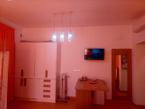 a kitchen with a large white cabinet and a table at Villa Margot in Agropoli