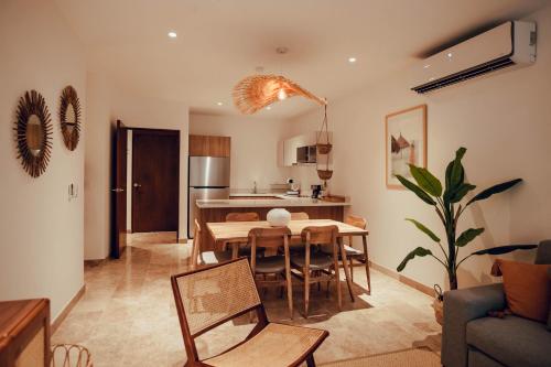 a kitchen and dining room with a table and chairs at Stylish Luxury Condo in the heart of Playa in Playa del Carmen