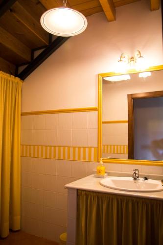 a bathroom with a sink and a mirror at Casa Canela in Colladas