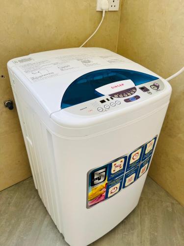 a large white cooler sitting next to a wall at Hansons Homestay in Kandy