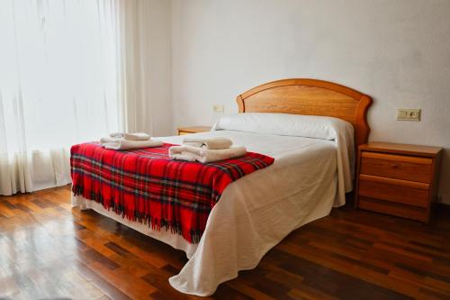 a bedroom with a bed with two towels on it at Parque del Sella in Arriondas