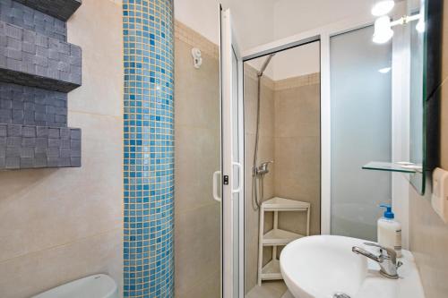 a bathroom with a shower and a toilet and a sink at Estudio 2 Costa Adeje in Adeje