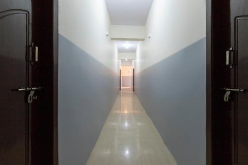 a hallway in a building with a long corridor at Sri Annapurneshwari Residency & Lodging in Hassan