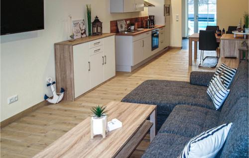 a living room with two couches and a table at Lovely Home In Gützkow With Kitchen in Gützkow