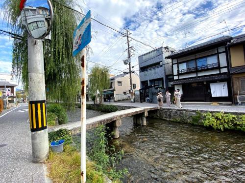 a bridge over a river with people walking on the street at Gion Shirakawa - Vacation STAY 24771v in Kyoto