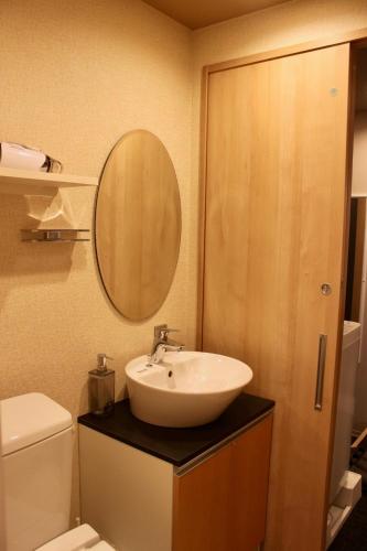 a bathroom with a sink and a mirror at Gion Shirakawa - Vacation STAY 24783v in Kyoto