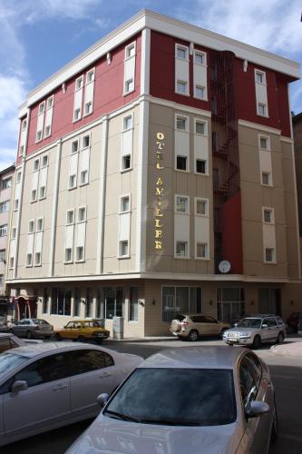 a large building with cars parked in front of it at OTEL AMİLLER in Erzurum