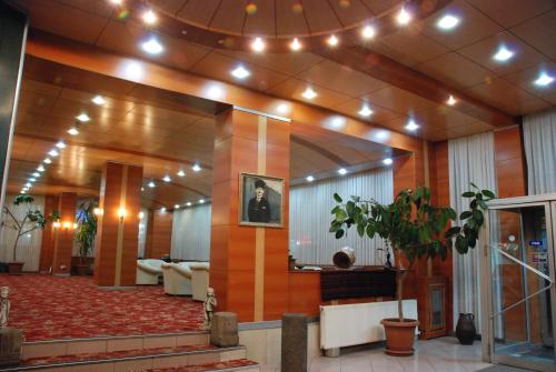 a lobby of a building with lights on the ceiling at OTEL AMİLLER in Erzurum