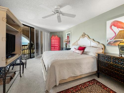 a bedroom with a bed and a flat screen tv at Hibiscus 301-A, 2 Bedrooms, Ocean Front, 3 Pools, Sleeps 6, Pet Friendly in Saint Augustine