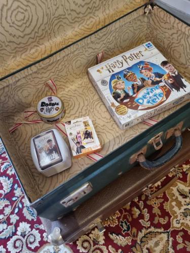 an open suitcase with a book and a magazine at La cabane des sorciers in Liévin