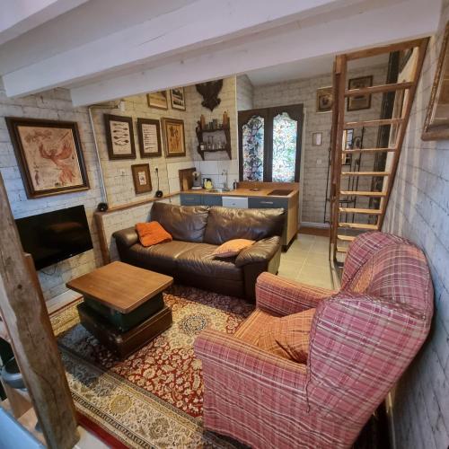 a living room with a couch and a table at La cabane des sorciers in Liévin