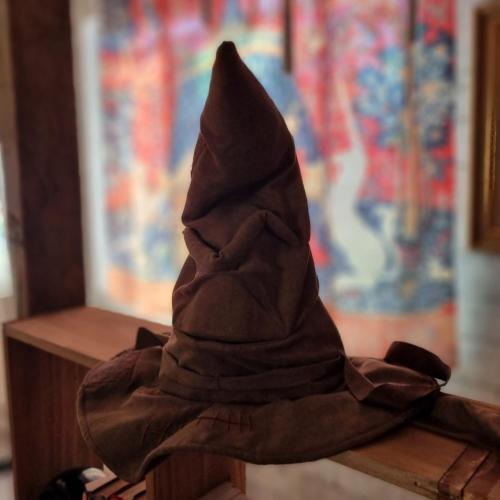 a hat sitting on top of a wooden table at La cabane des sorciers in Liévin