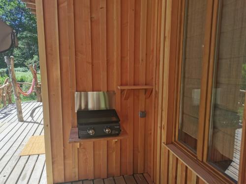 an open door with a radio sitting on a porch at Gîte nature Au pied des hêtres in Vitrac-sur-Montane